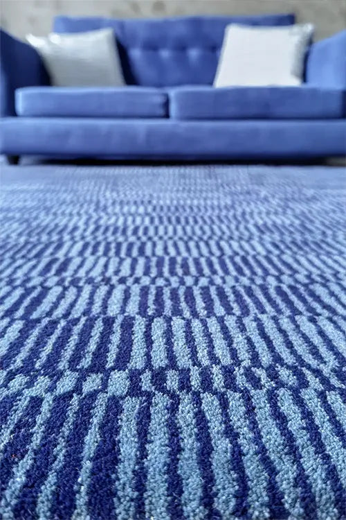 Blue textured rug with geometric pattern in a room setting