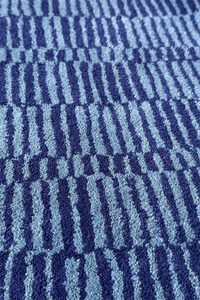 Navy and blue striped wool rug with textured surface, designed for coastal living room decor

