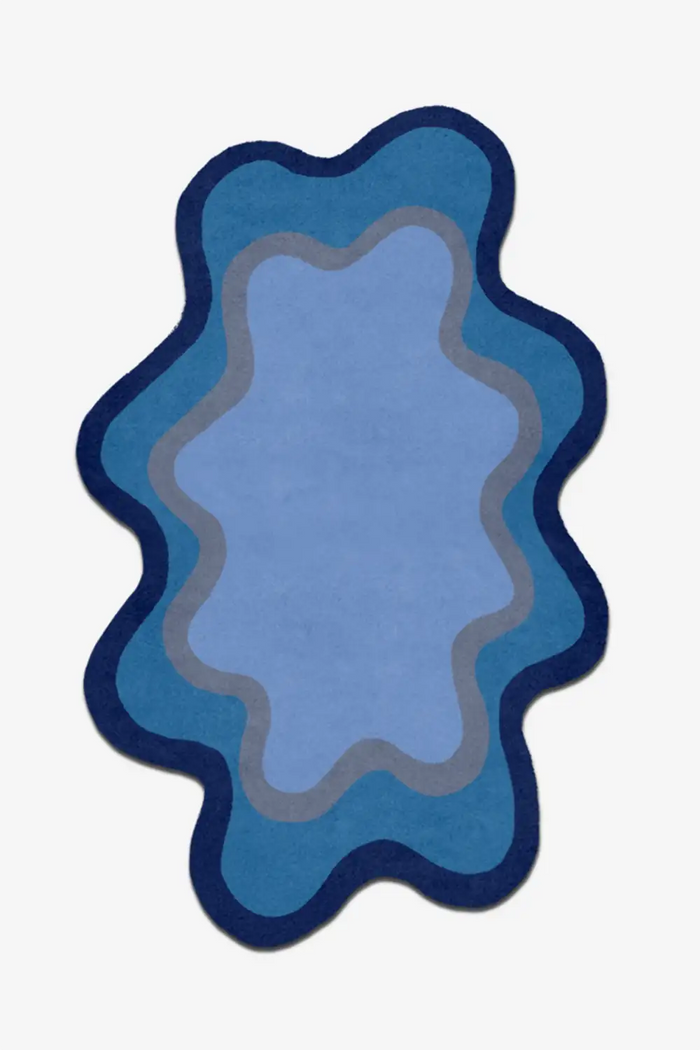 Blue abstract rug with wavy design on a white background