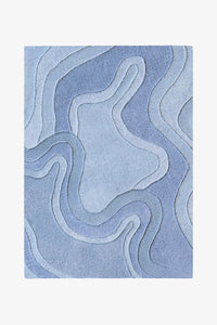 A square area rug with an abstract, layered topographic pattern in shades of light blue, shown flat against a light gray background.