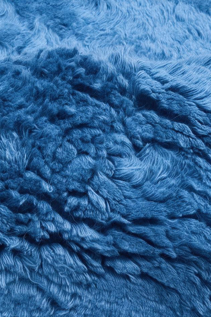 close up texture view of a blue wool shaggy rug