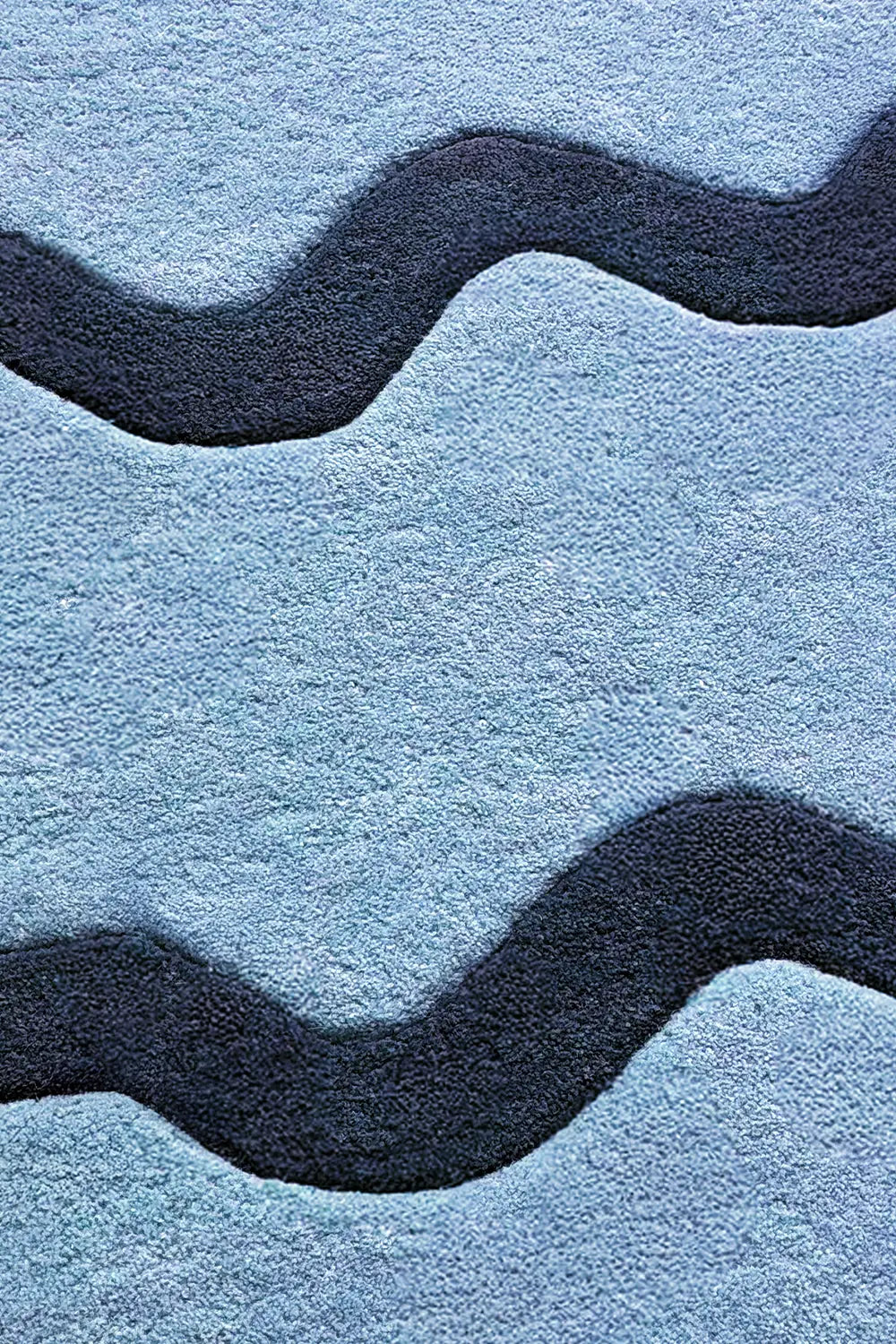 Close-up of navy and light blue wavy stripe wool rug, bold modern graphic runner rug
