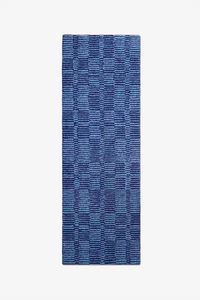 Blue patterned modern wool runner rug on a white background