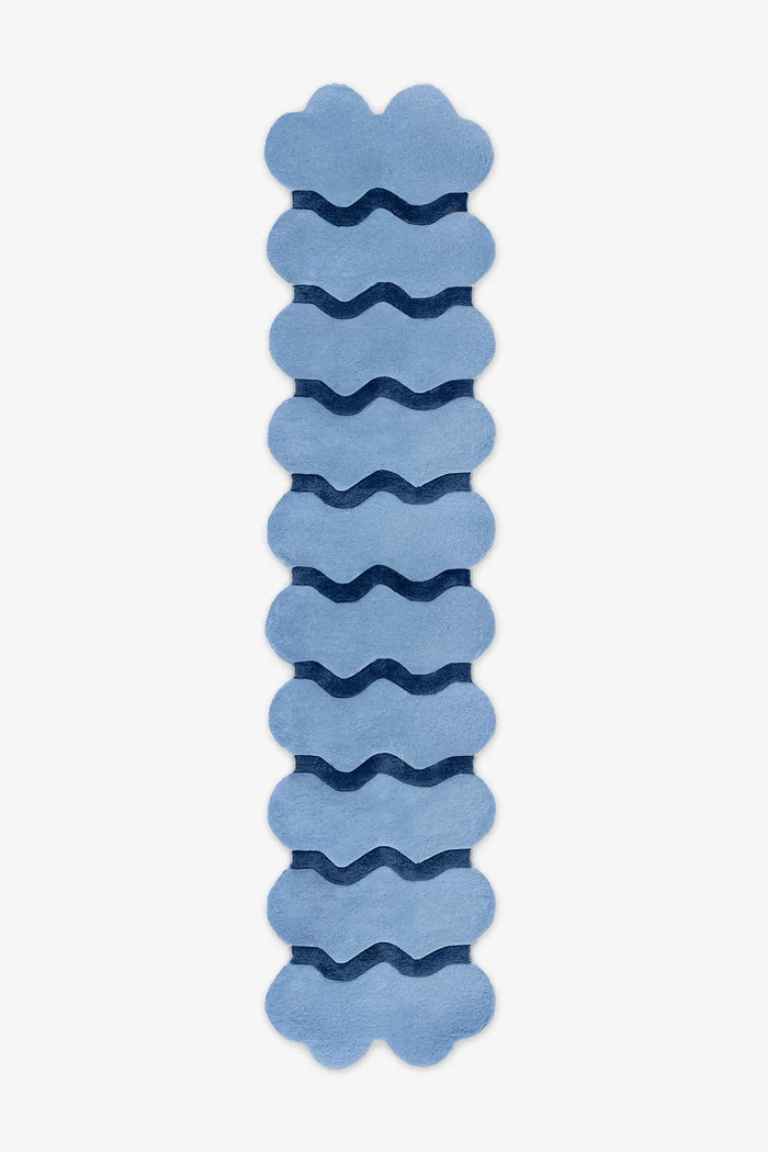 Extra long sculptural blue wool runner with navy waves, ideal for colorful hallway styling