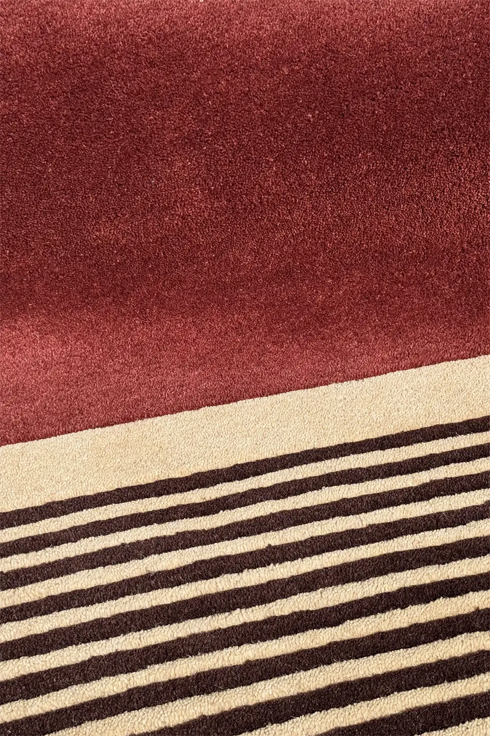 Neutral midcentury-style wool area rug with red, beige, and plum color blocks