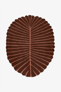 Round brown rug with leaf pattern on a white background