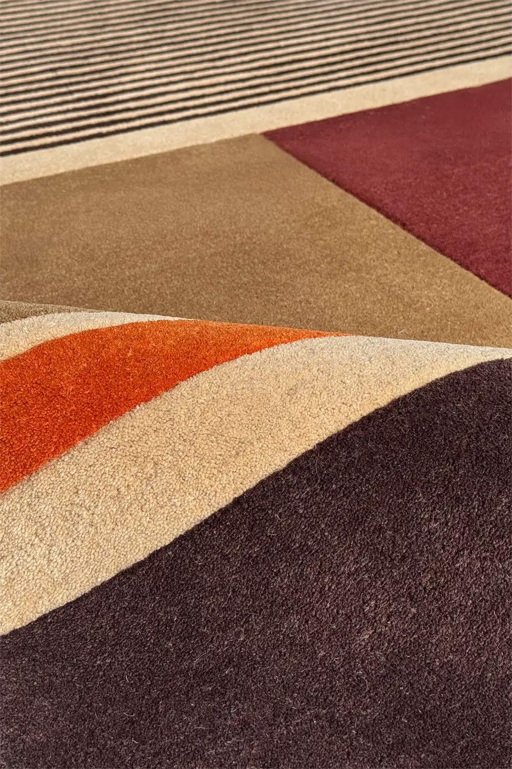 Striped wool rug in earthy brown and red tones for modern rustic interiors