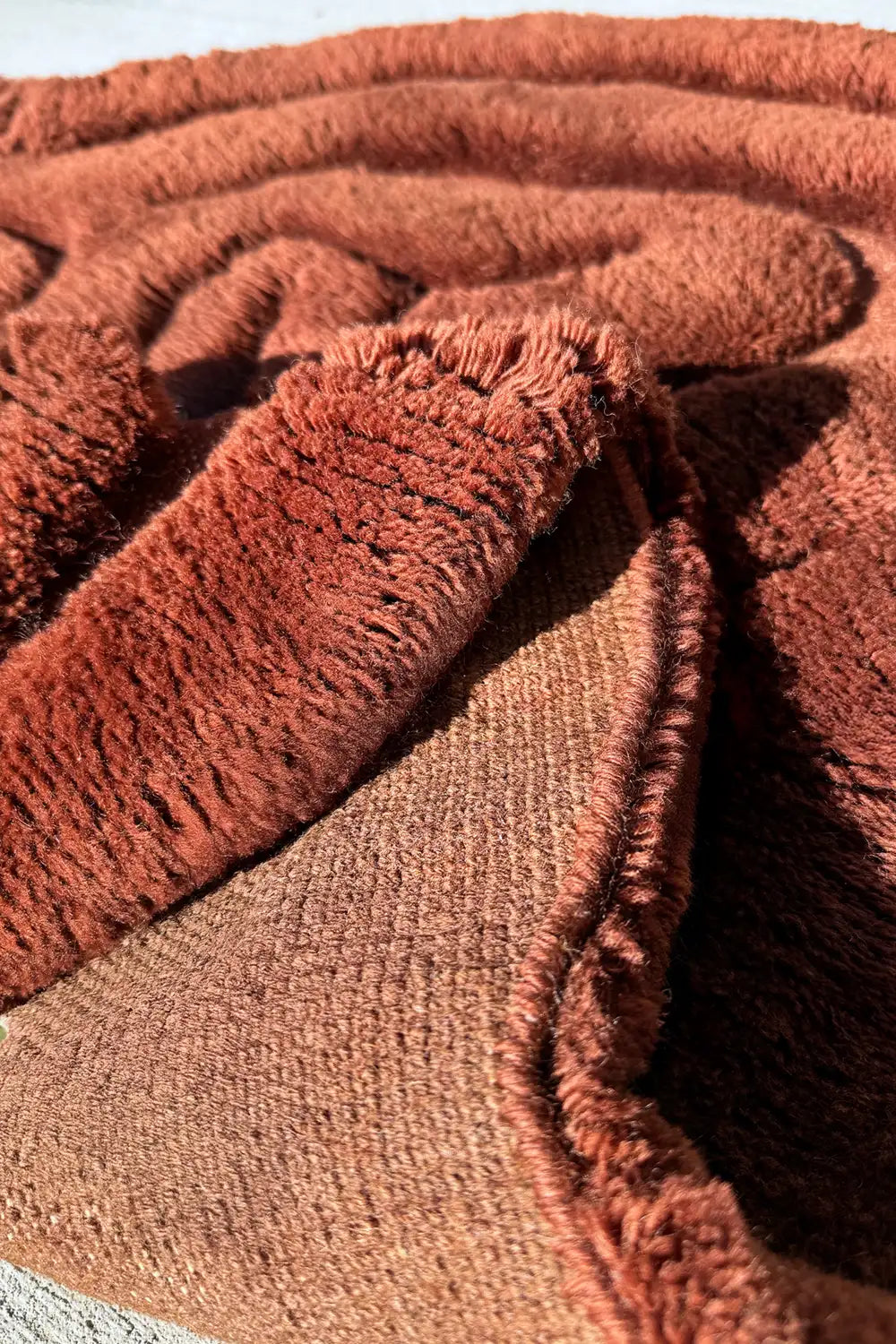 Handmade brown wool shaggy rug featuring deep sculptural grooves and modern abstract design