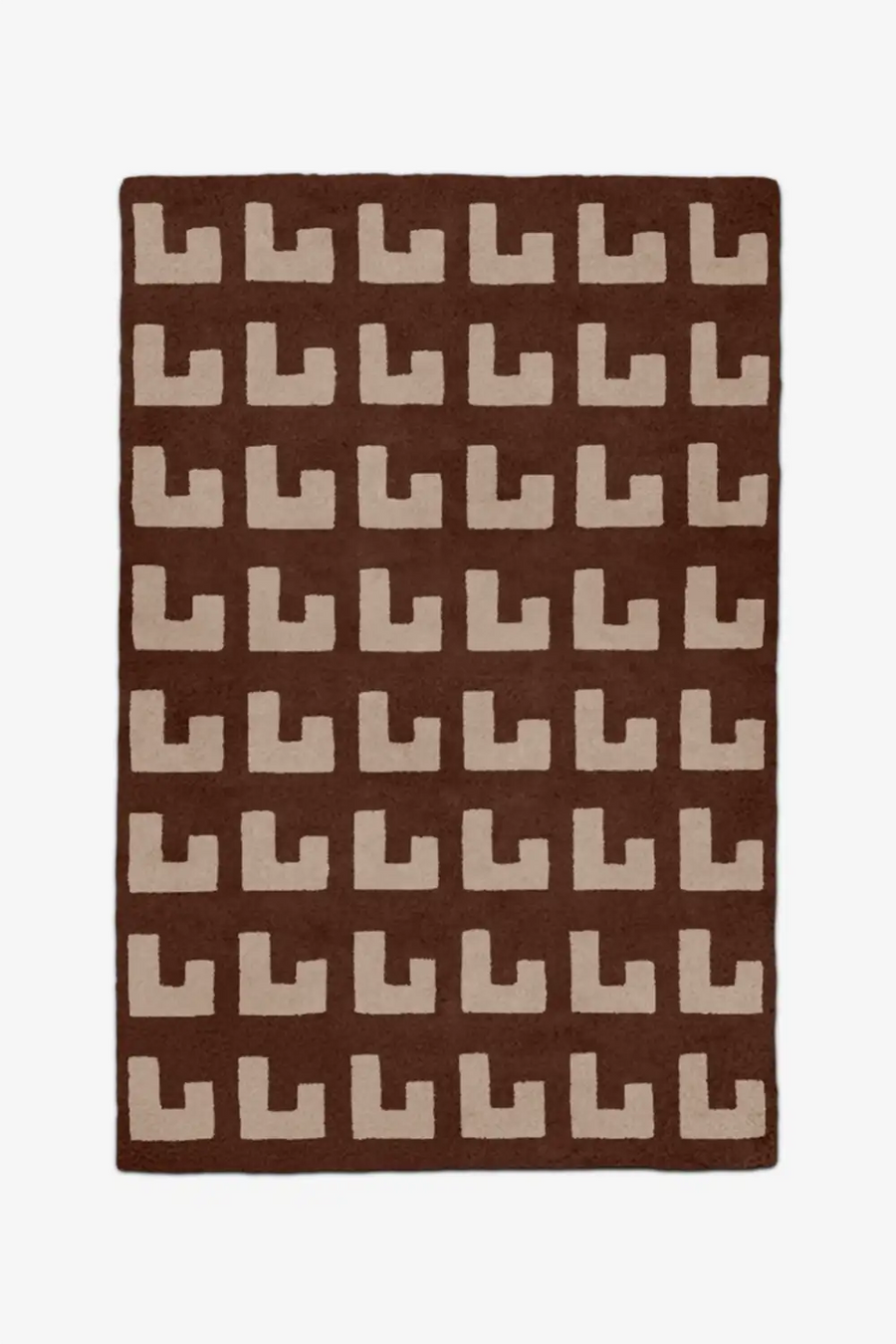 Brown rug with beige geometric patterned wool rug on a white background
