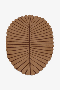 Brown leaf-shaped rug on a white background