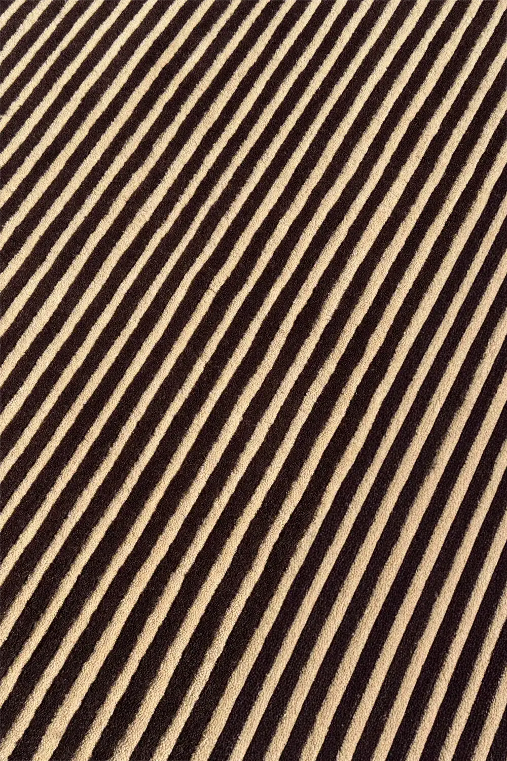 Brown and tan striped wool rug with a tight modern weave and warm neutral tone