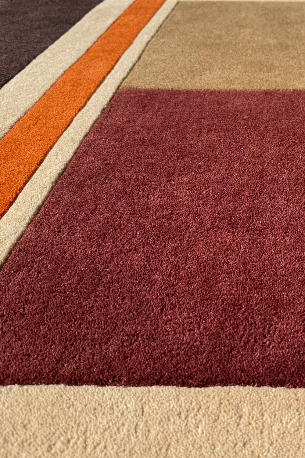 Brick red and brown striped wool rug with tan accents in bold linear pattern