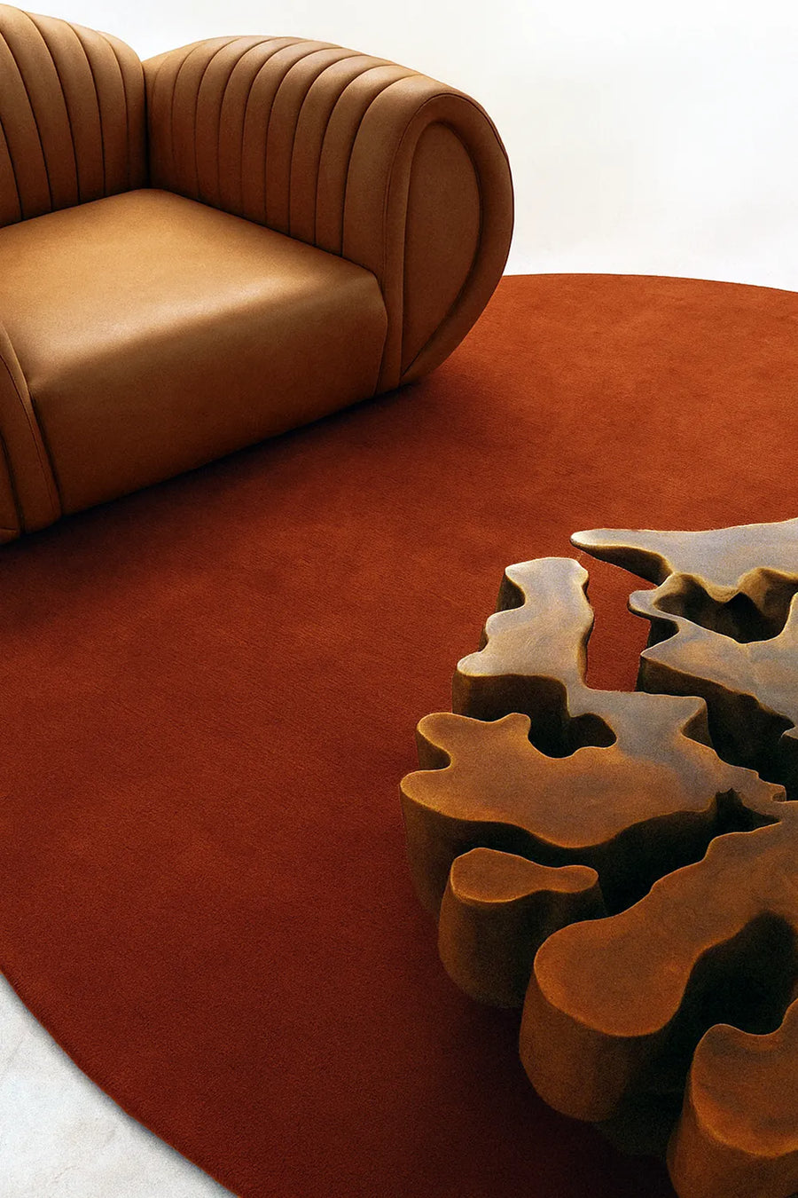 Burnt orange 8ft round rug styled under a sculptural coffee table and curved sofa for modern living rooms