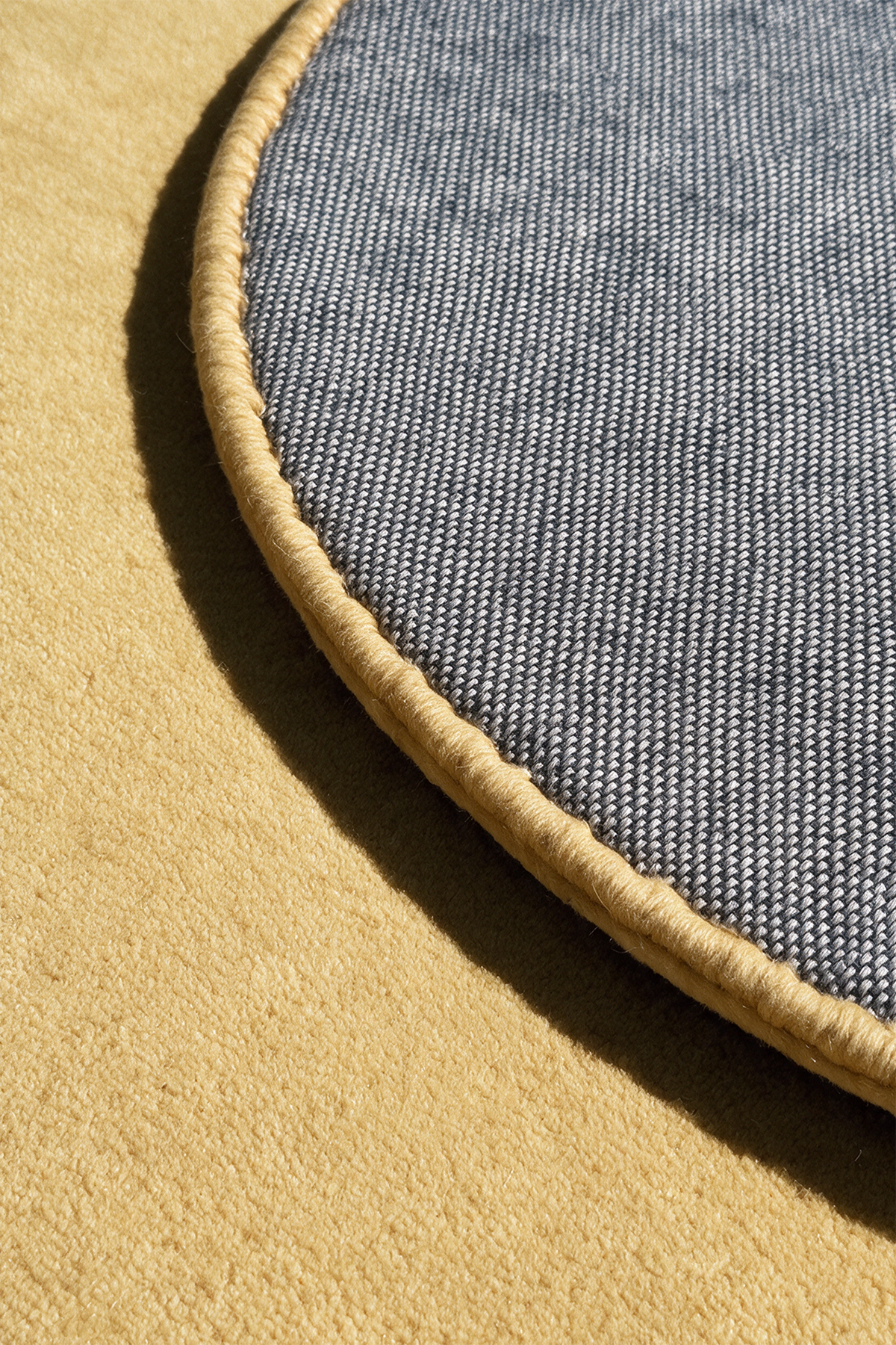 close up view of a butter yellow rug's backing and edge binding | Cotton backing