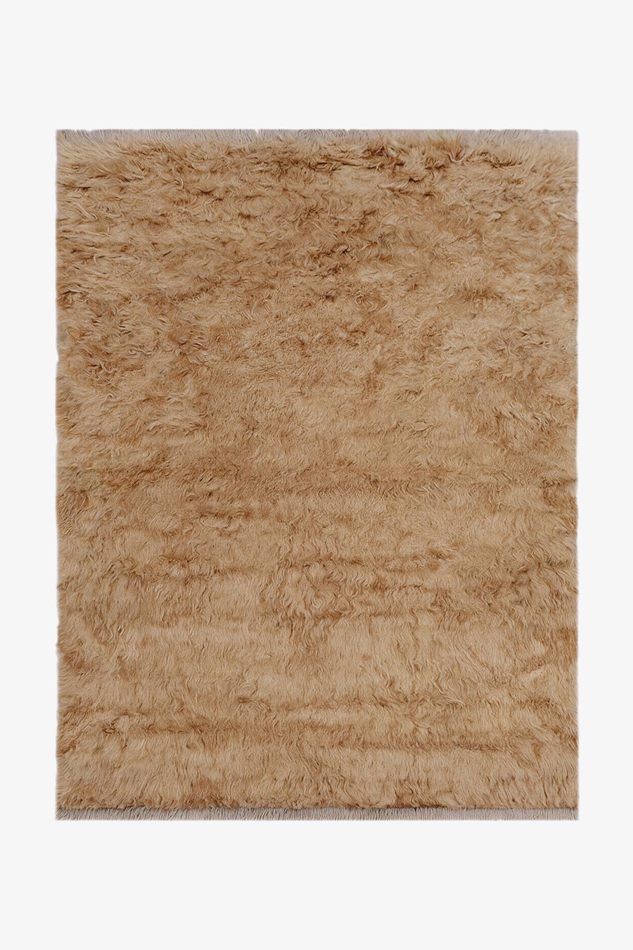 A rectangular shag rug in a warm tan camel shade, shown flat against a plain white background.