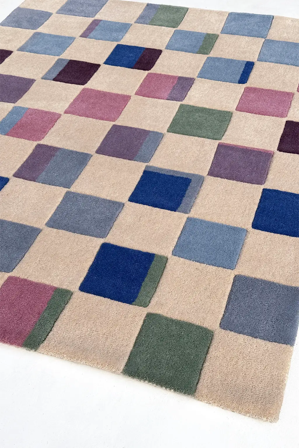 Checkered rug with multicolor squares on a beige background
