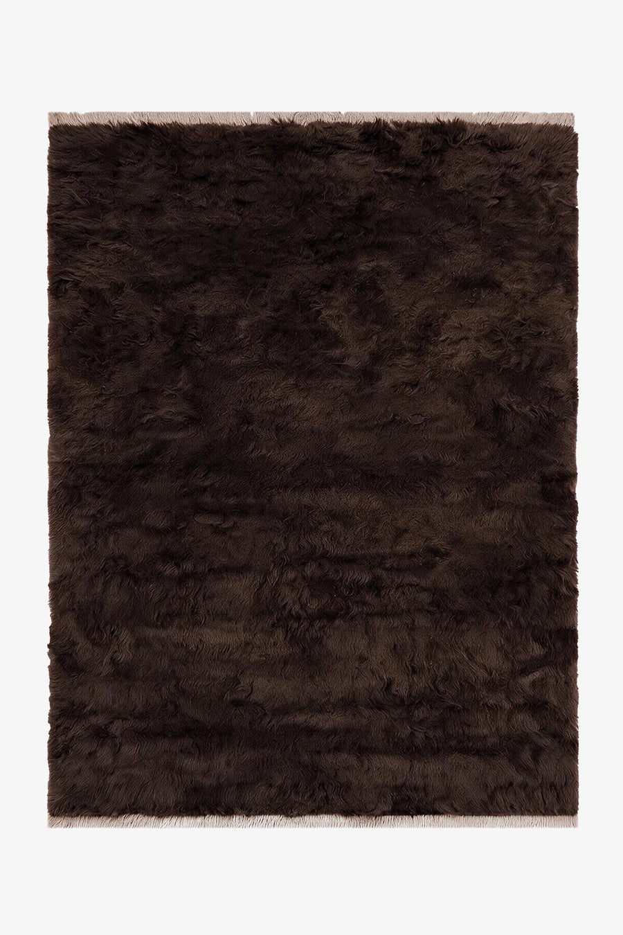 A dark brown shaggy area rug with a textured, fluffy pile and fringed edges, shown flat against a plain white background.