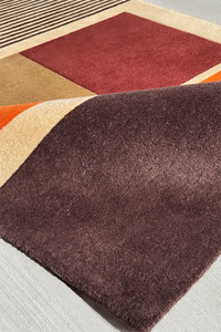 Luxury brown and red wool rug with earth-toned stripes and subtle sculpted texture