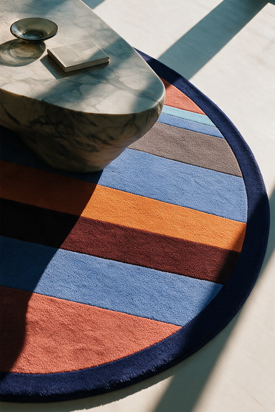 round area rug with a modern colorful striped design lifestyle