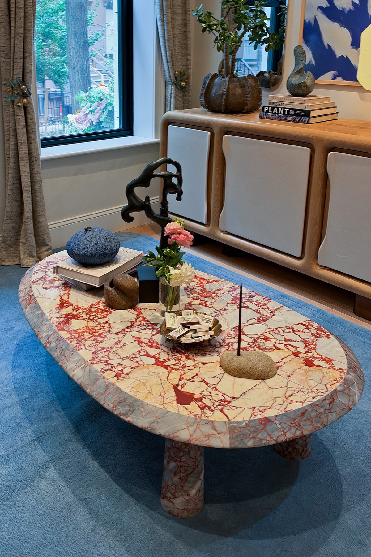 light blue wool rug with a marble coffee table on top in an urban living room