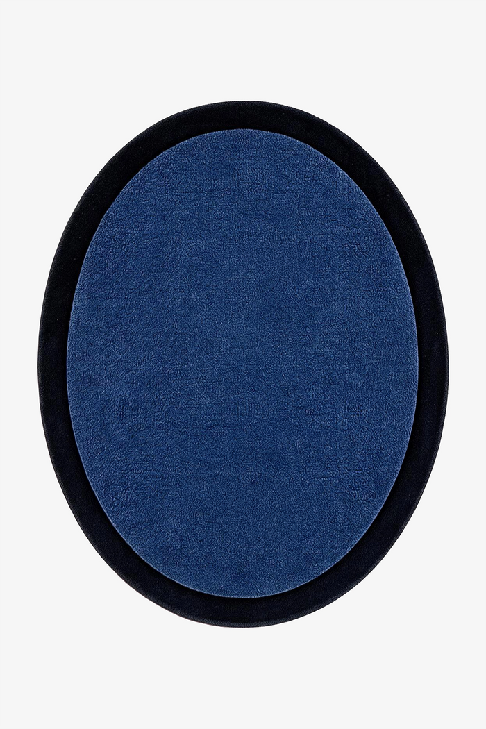 An oval-shaped rug featuring a deep blue textured center surrounded by a thick navy border, shown against a plain white background.