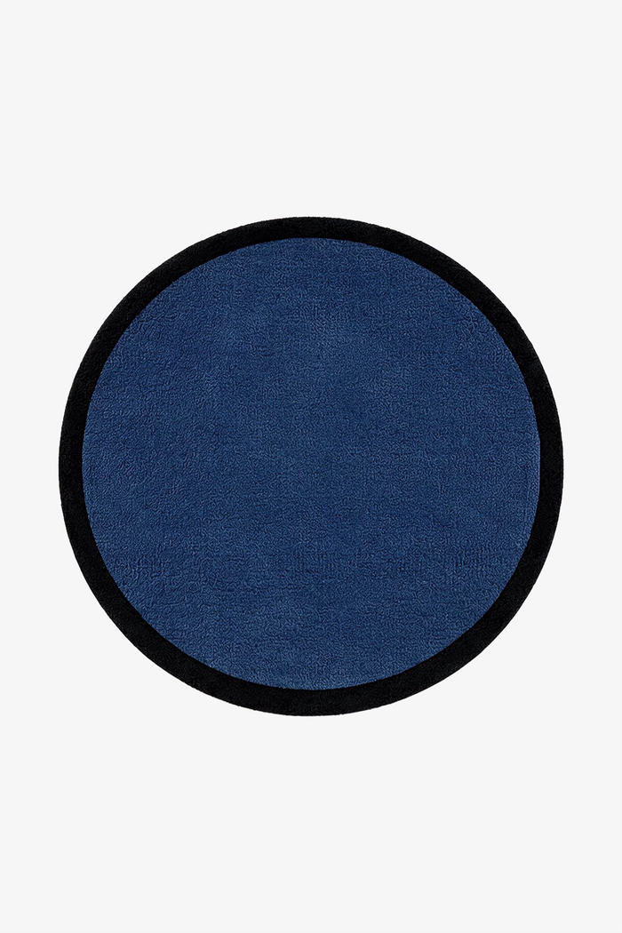 A circular navy blue rug with a contrasting black border, shown flat against a solid white background.
