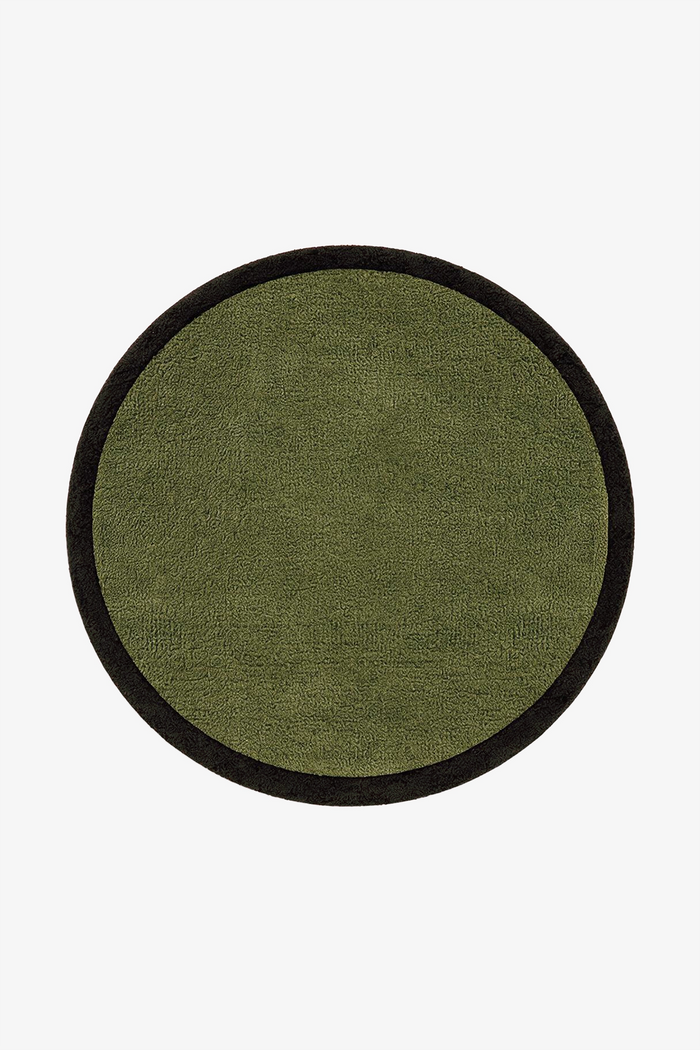 A round rug with an olive textured center and a contrasting forest border, shown flat against a plain white background.
