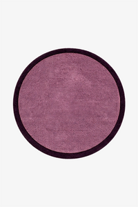 A round area rug with a textured mauve-purple center and a contrasting dark purple border, shown flat against a light gray background.