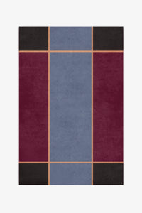 Rectangular rug with a geometric pattern of squares in blue, red, and black on a white background