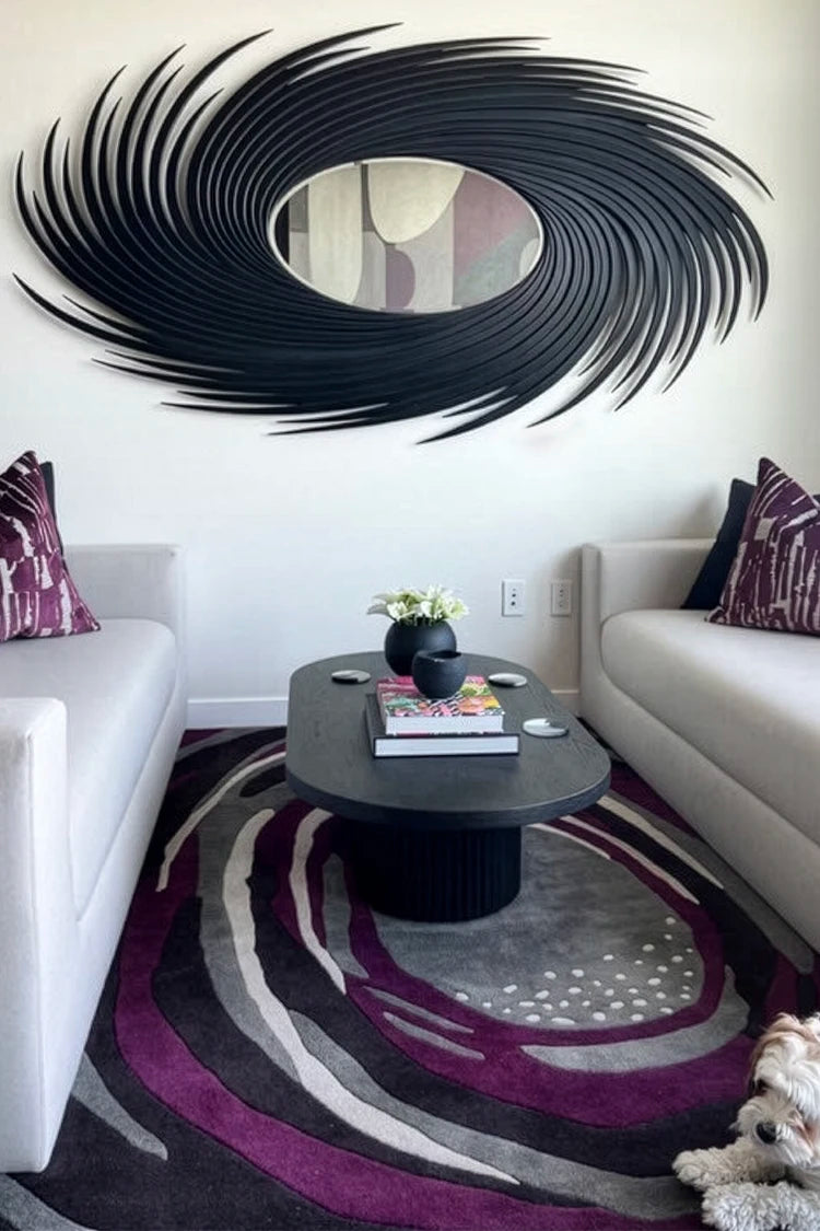 Modern living room with a large black spiral wall art piece and matching rug