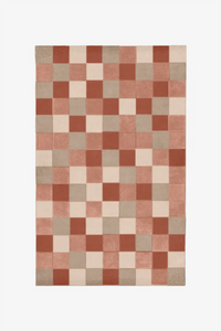 Multicolored checkered wool rug in earthy neutral tones like terracotta and sand