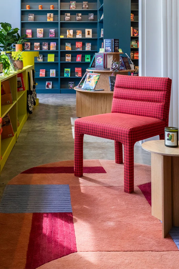 custom oval rug with red and blue colors on a white background