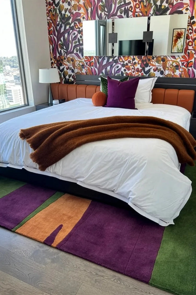 Colorful striped custom rug with purple, green, and orange on a white background