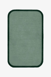 Rectangular green rug with a black border on a white background