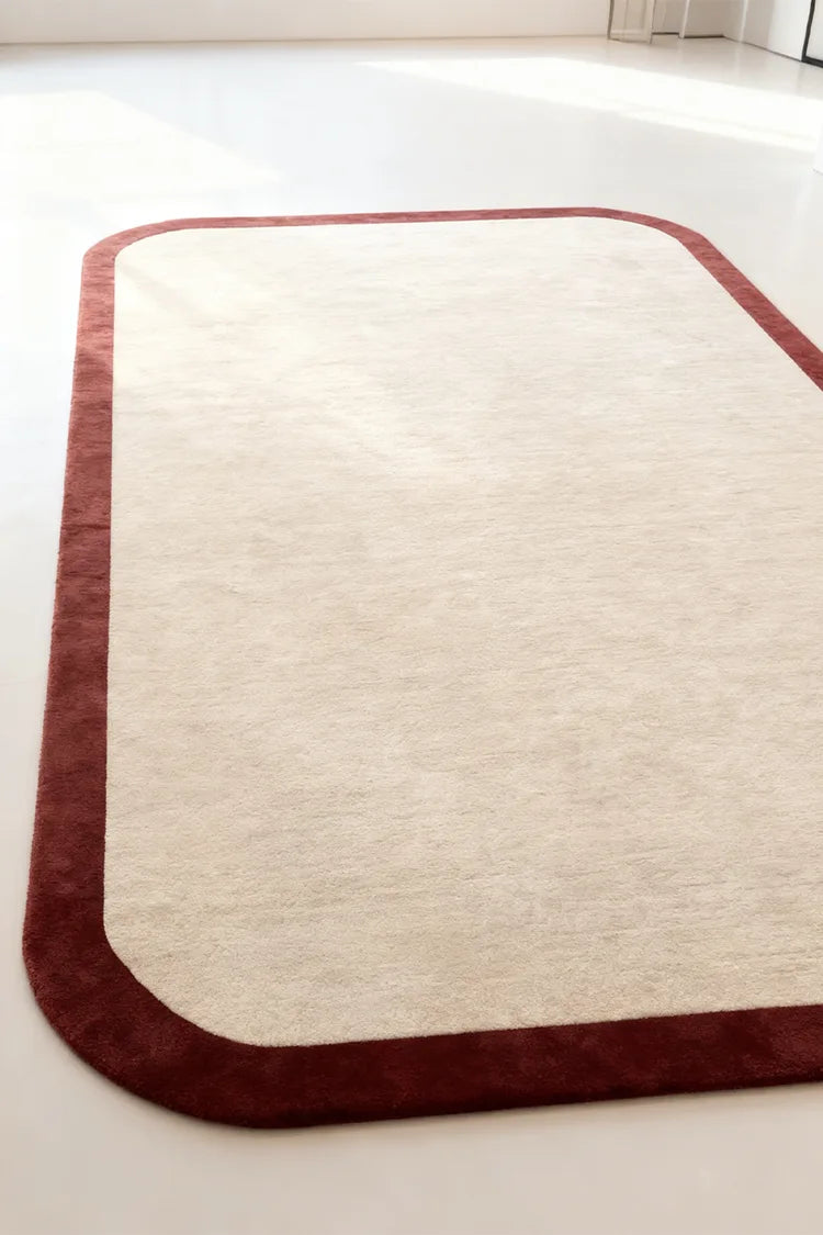 Rectangular custom rug with red border on a white background