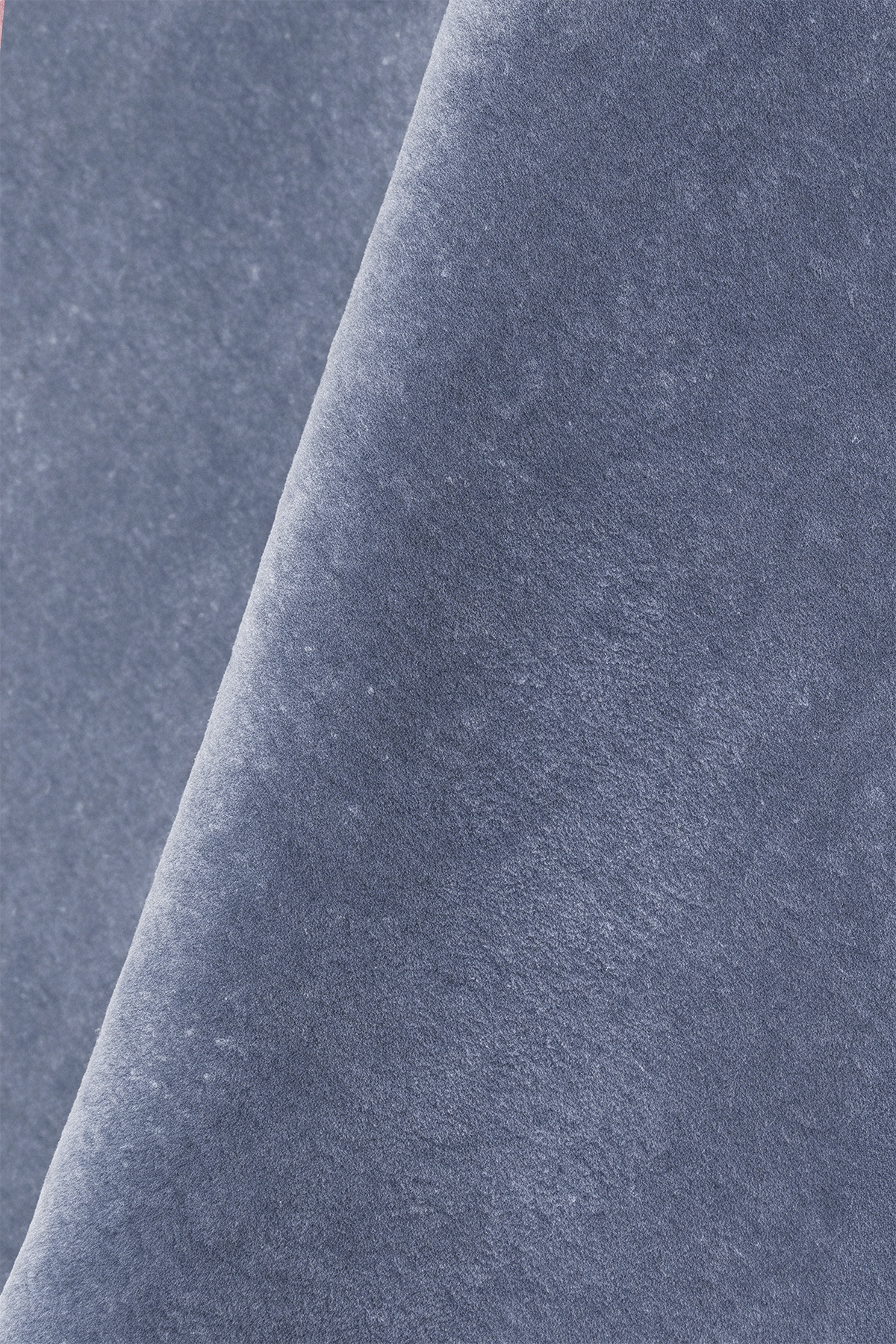 close up texture of a slate dusty blue wool rug hand-tufted soft pile