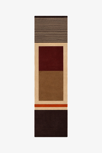 A long, narrow geometric runner rug with blocks and stripes in beige, brown, burgundy red, and dark brown, shown flat against a light gray background.