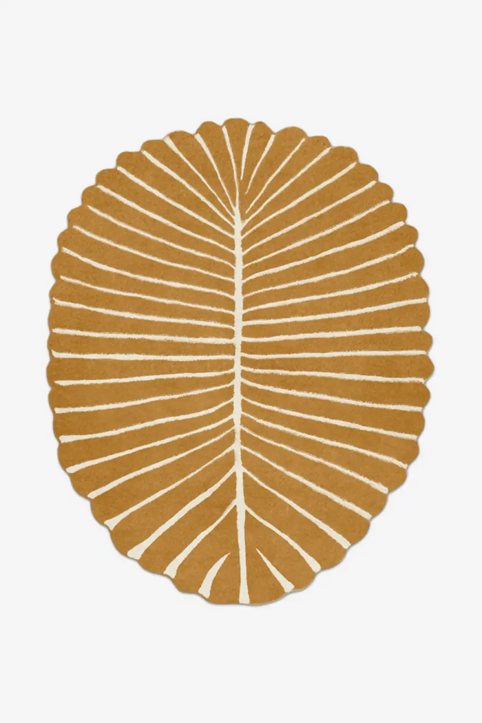 Decorative wool area rug with a leaf pattern on a white background