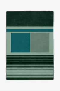 large green rug with geometric pattern on a white background