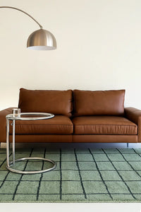 modern green living room wool knotted rug with black grid pattern lifestyle