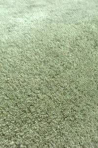 Close-up texture of sage green wool area rug, plush and soft modern living room rug