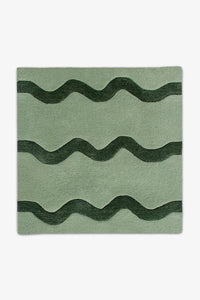 Green and dark forest green square wool rug featuring playful wavy stripes, ideal for 8' square rugs in kids' rooms or colorful kitchens