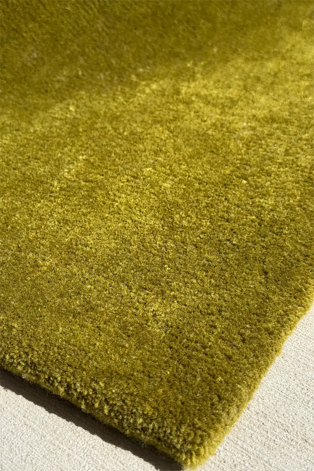 Close-up of a handmade olive green textured rug