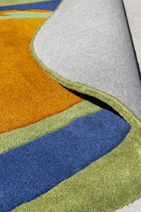 Hand-tufted oval area rug in green and navy with soft orange, perfect as a funky wool rug in unique sizes