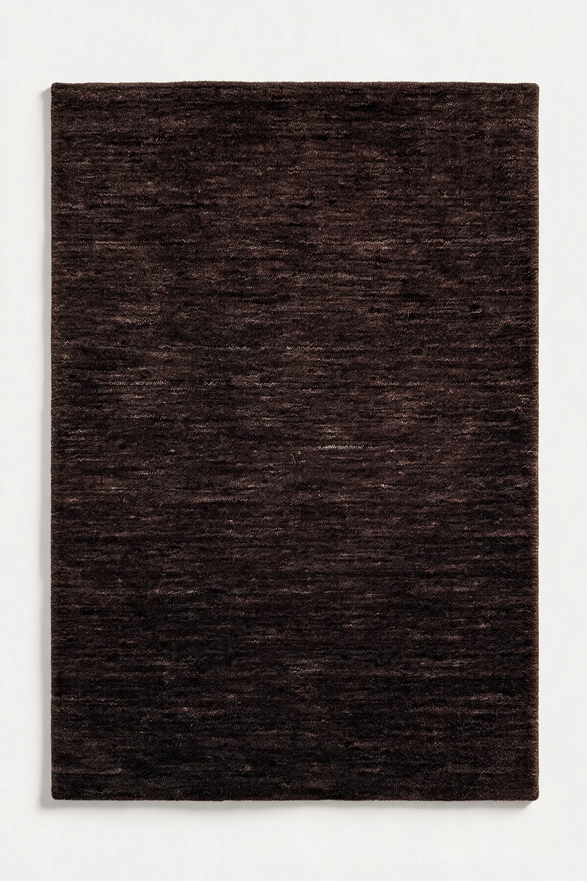 dark brown loomed wool rug with natural striation pattern | Haven in Cocoa without stitched binding
