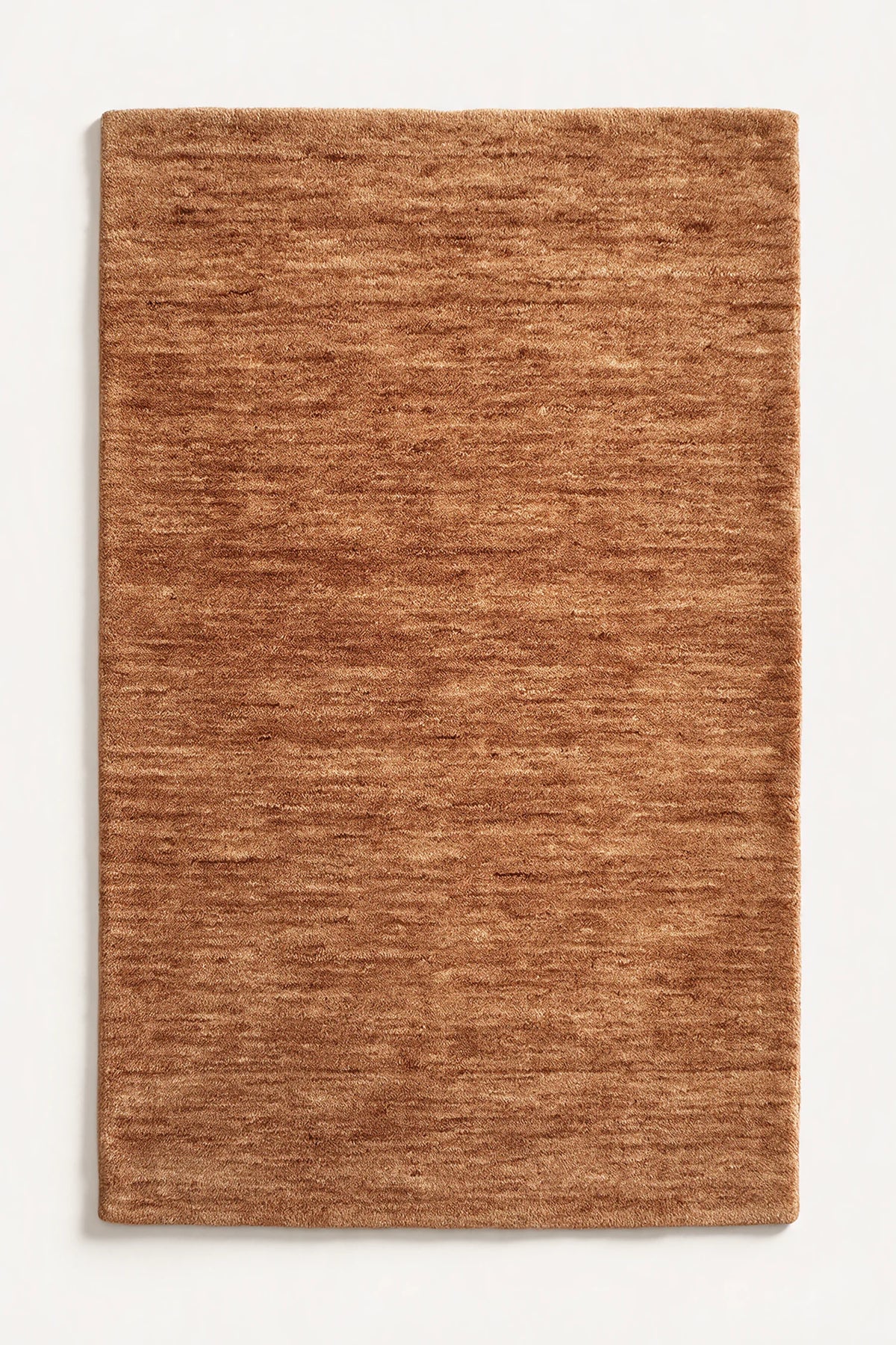 a camel haven hand-loomed wool rug with plain edges and no stitched binding, shown flat on a white background  | Haven in Camel without stitched binding