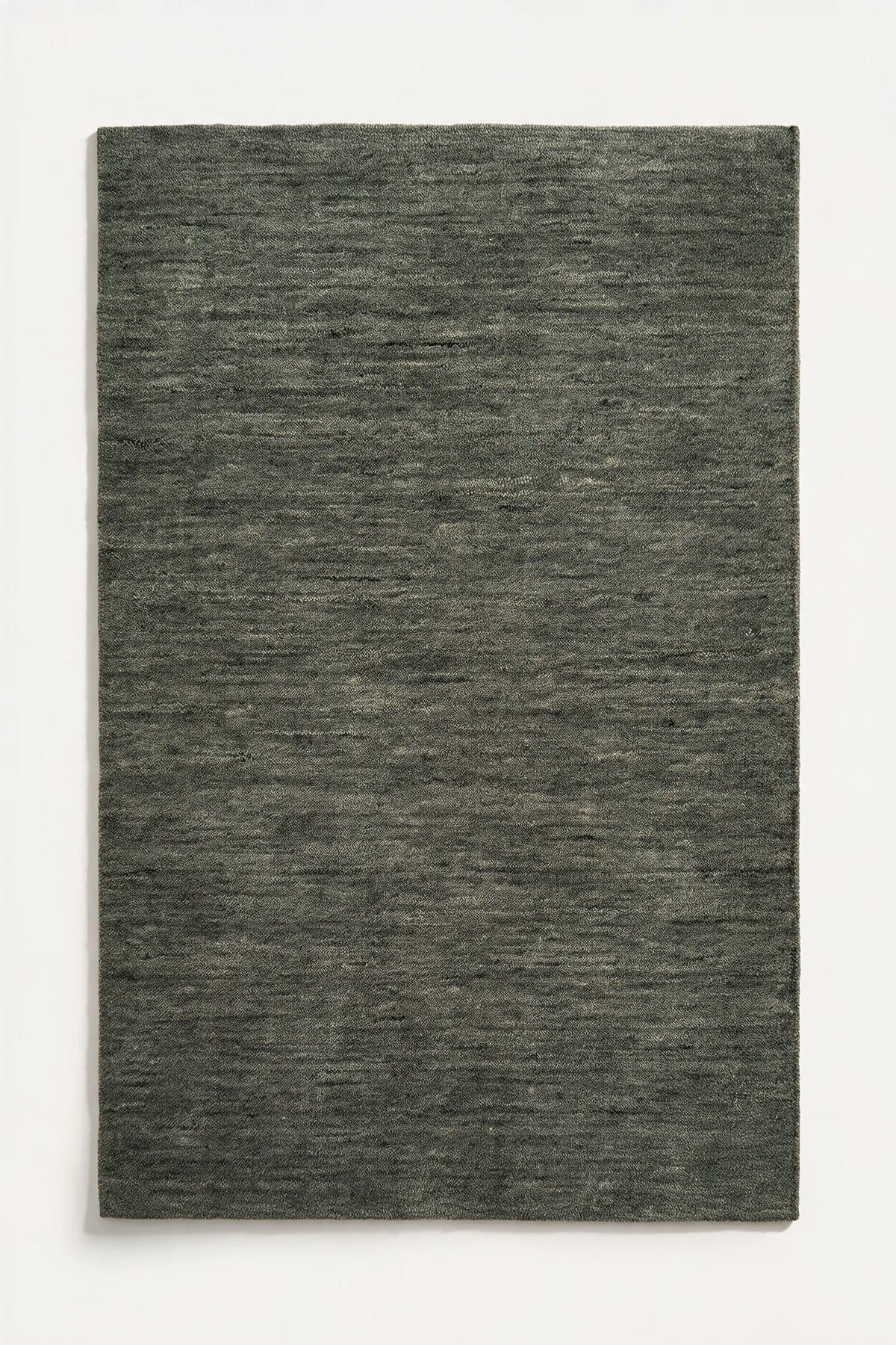 a sage green haven hand-loomed wool rug with plain edges and no stitched binding, shown flat on a white background