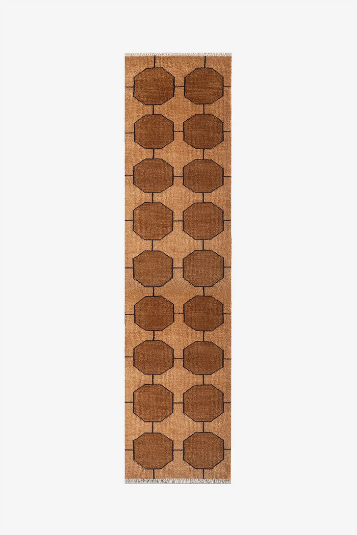 warm golden brown patterned runner rug on a white background