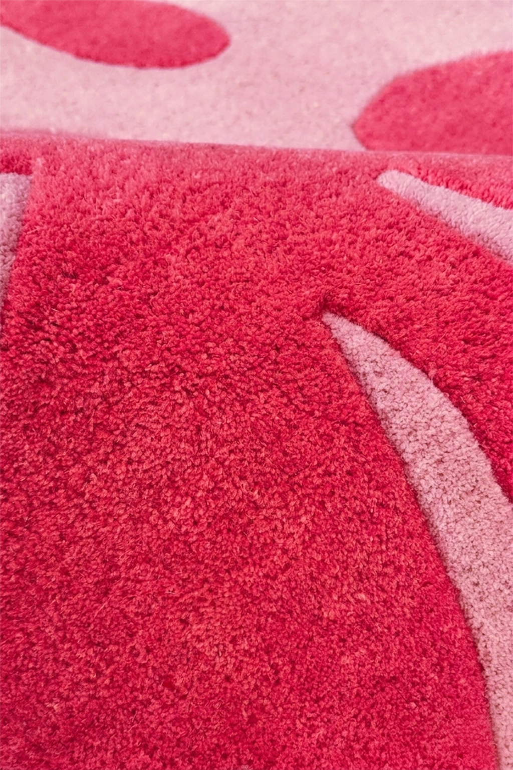 Close-up of a pink and red floral-patterned rug