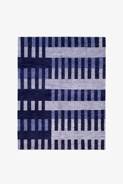 Rectangular area rug with blue and gray geometric pattern on a white background
